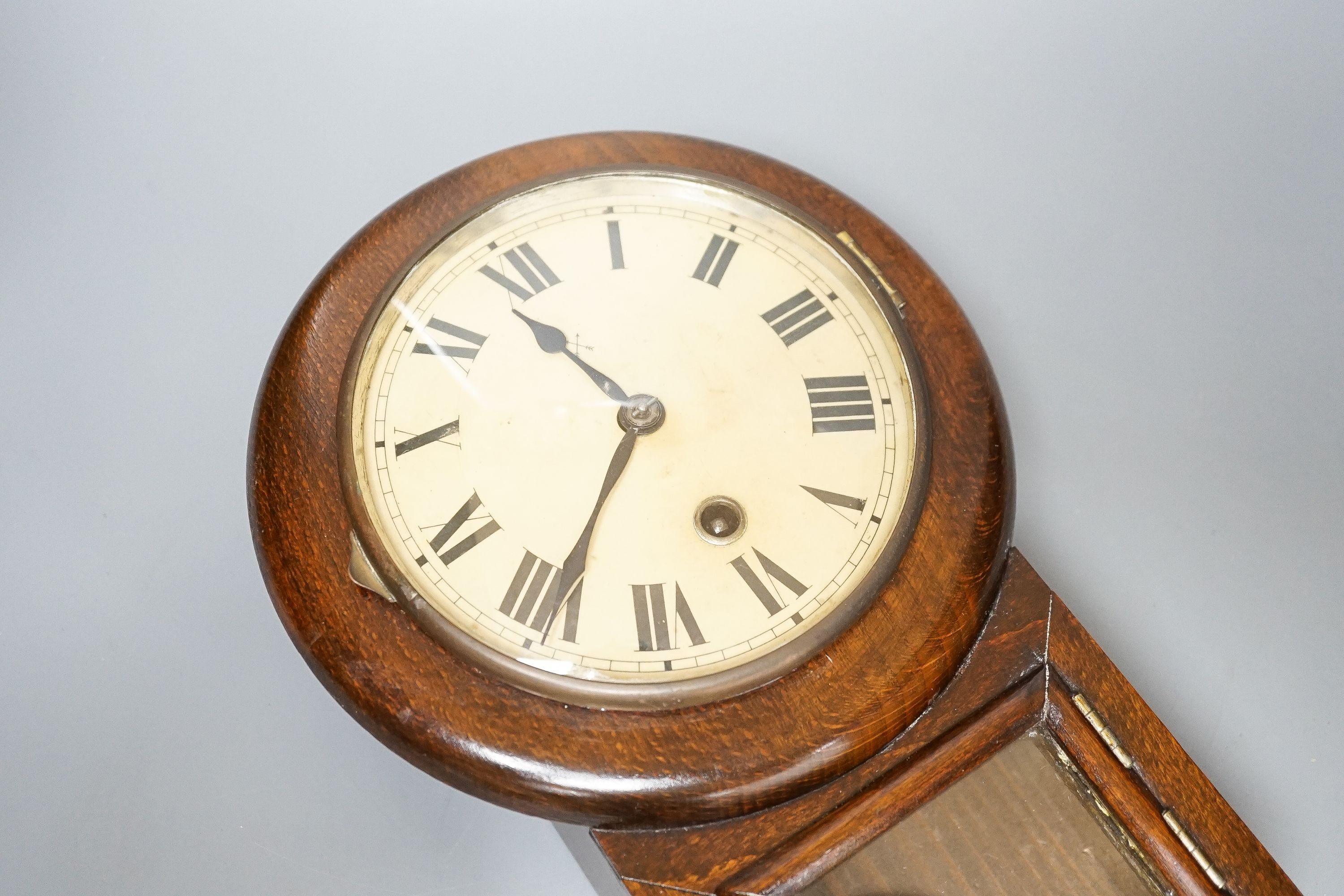 A small late 19th century beech drop dial timepiece with key and pendulum 31cm